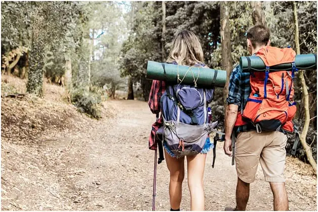 carrying backpacks and hiking outdoor together