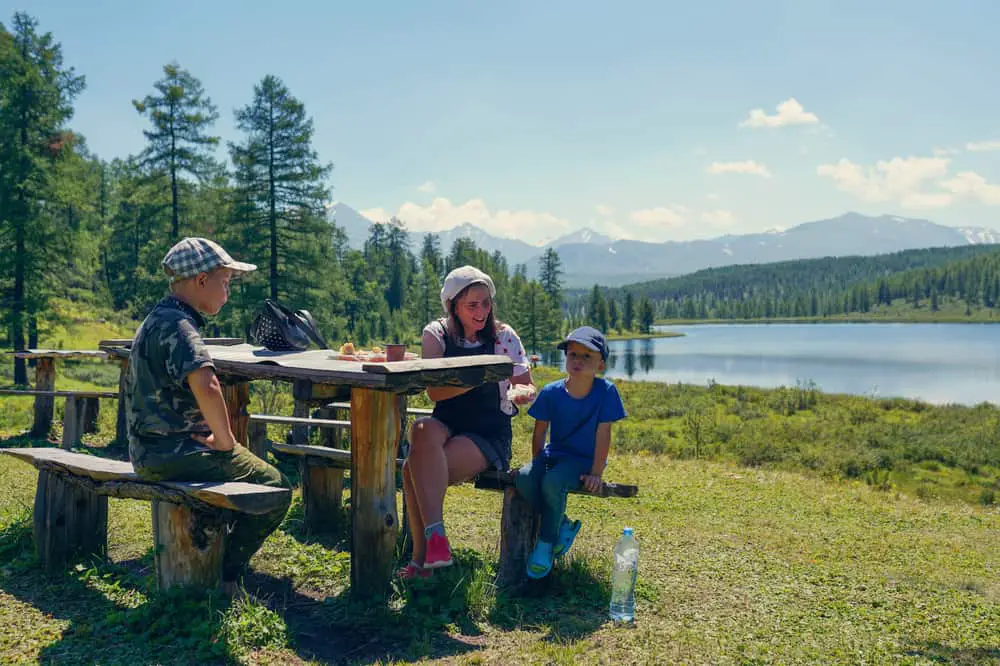 mother eating in the mountains with sons